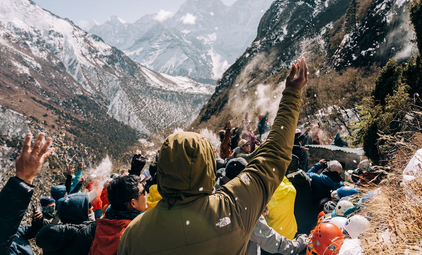 Team members participate in a traditional Puja ceremony—asking for permission and safety before their climb.
