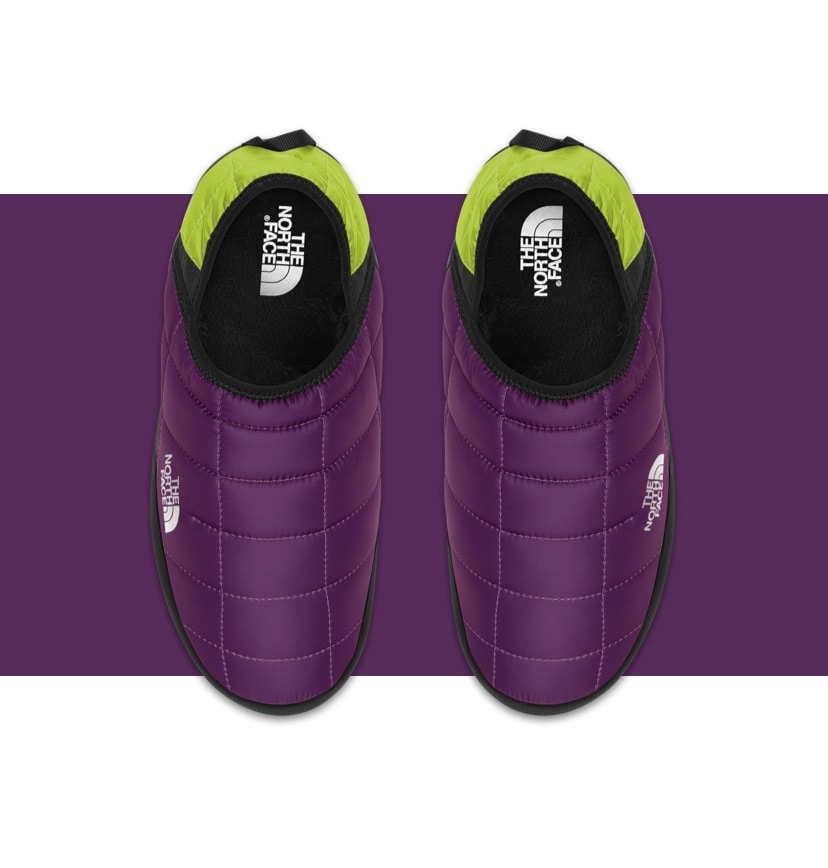 A pair of multi-colored Nuptse Mules on a gray background. 