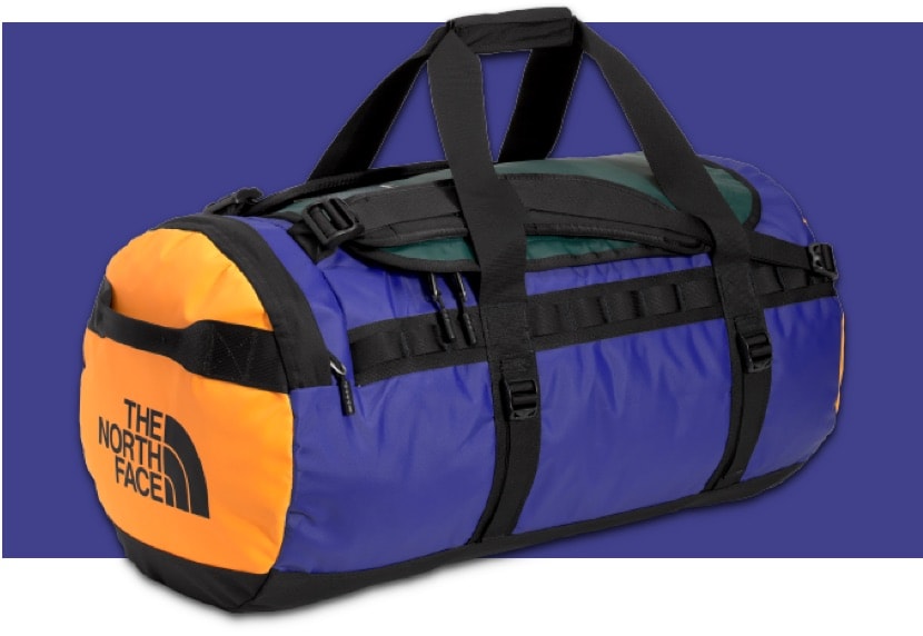 A blue, green and orange Base Camp Duffel on a blue background. 