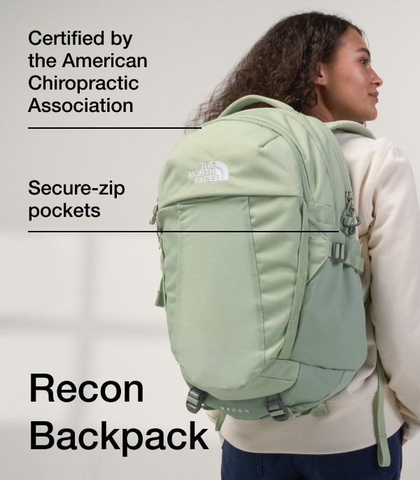 A woman faces away, showing her light green Recon backpack.