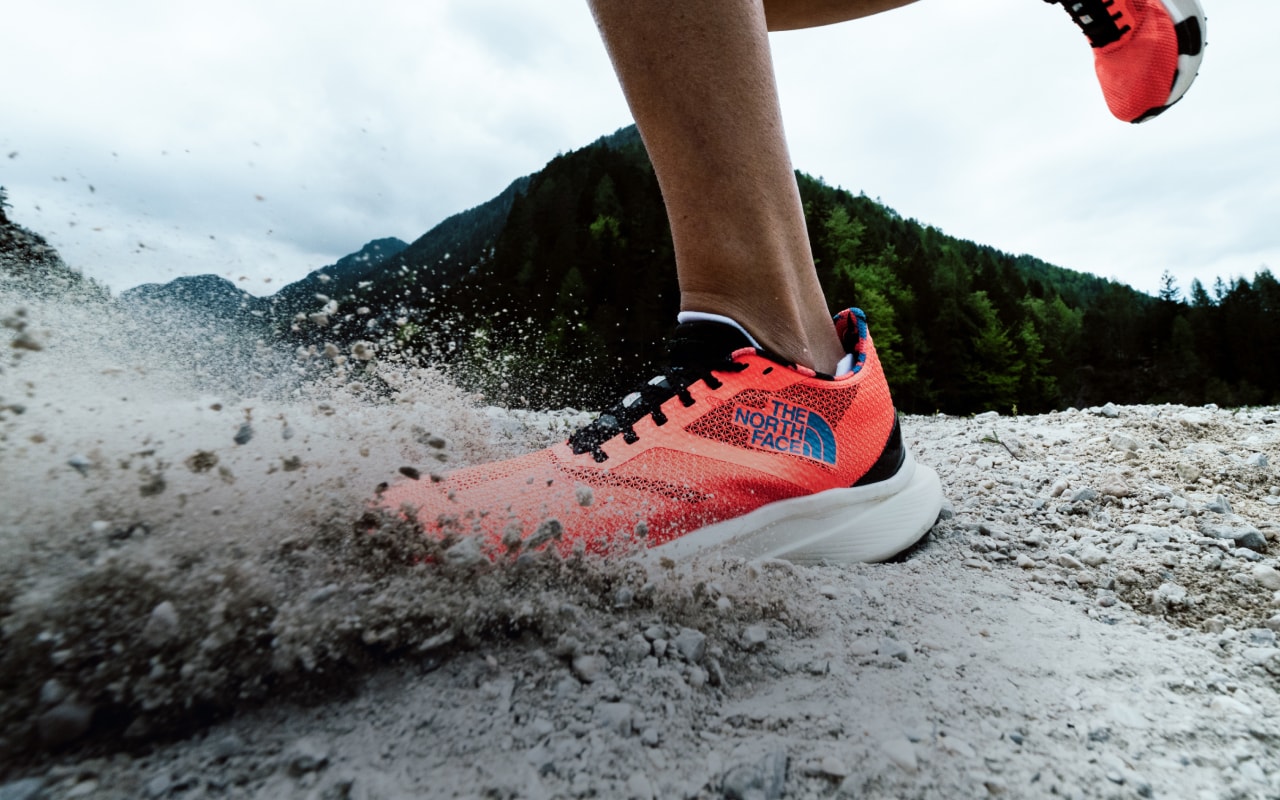 Close up of a runner’s shoe as it impacts the dirt.