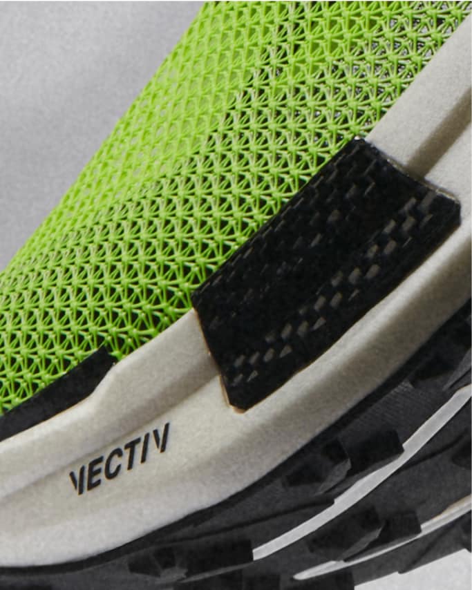 A close-up view of a shoe focusing on the VECTIV plate and high-rebound midsole.  