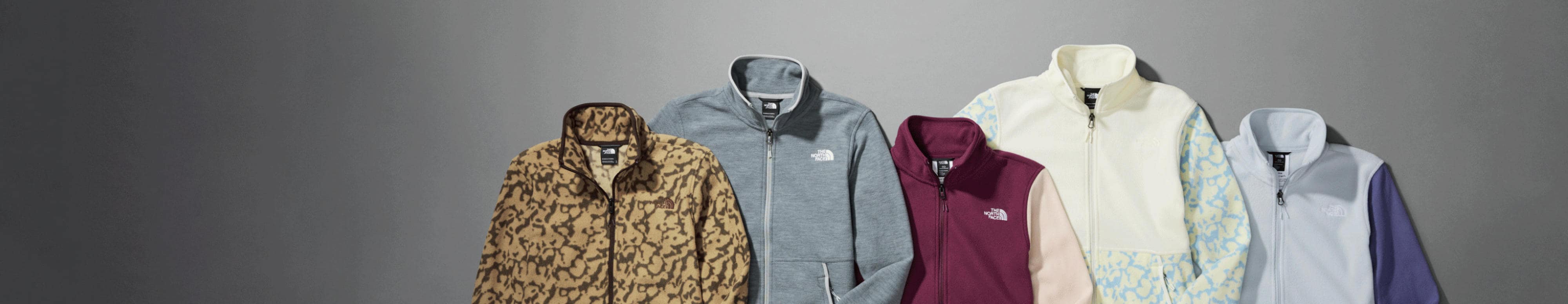 Laydown of studio photos of different fleece jackets from The North Face.