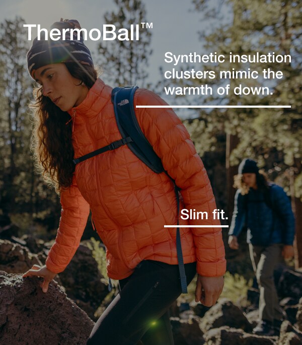 A hiker wearing a ThermoBall™ jacket from The North Face hikes with a friend.