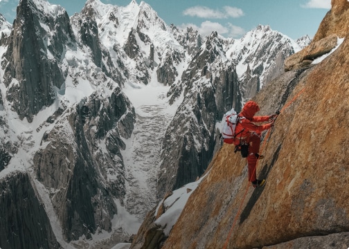 A person winter climbs in Summit Series gear from The North Face.
