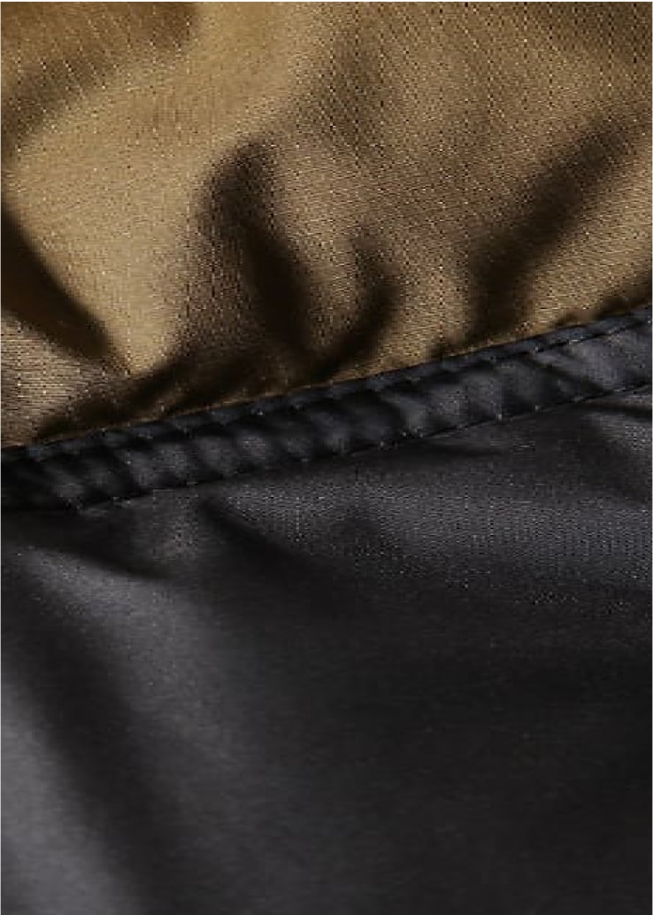A close-up of black and tan fabric used on a product featuring Heatseeker™ Eco insulation. 