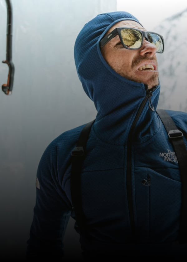 An ice climber wearing a FUTUREFLEECE™ layer looks into the distance.