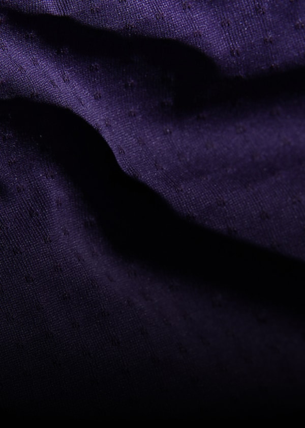 An extreme close-up of purple DotKnit fabric. 