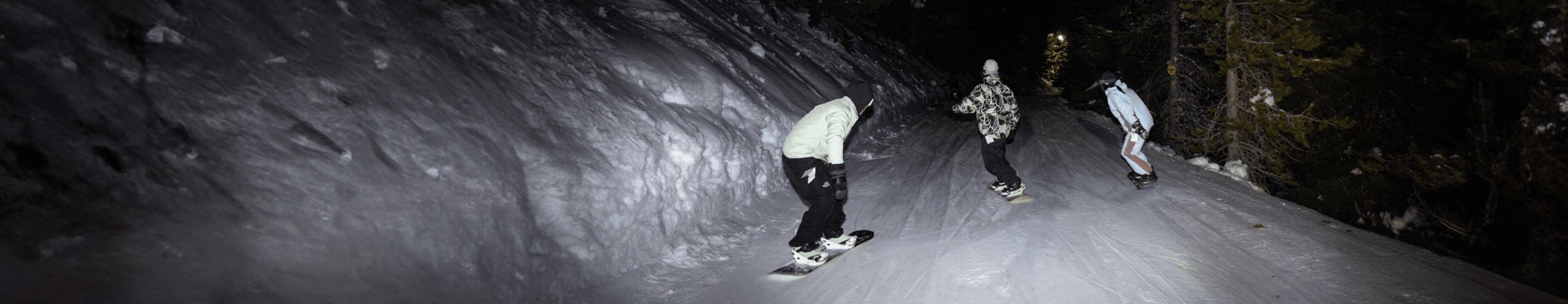 Three snowboarders ride at night in a new freeride collection from The North Face.