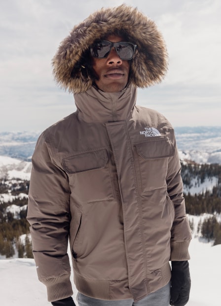 The North Face mountaineer Conrad Anker stands on a snowy mountain in a navy blue Men’s ’73 The North Face Parka