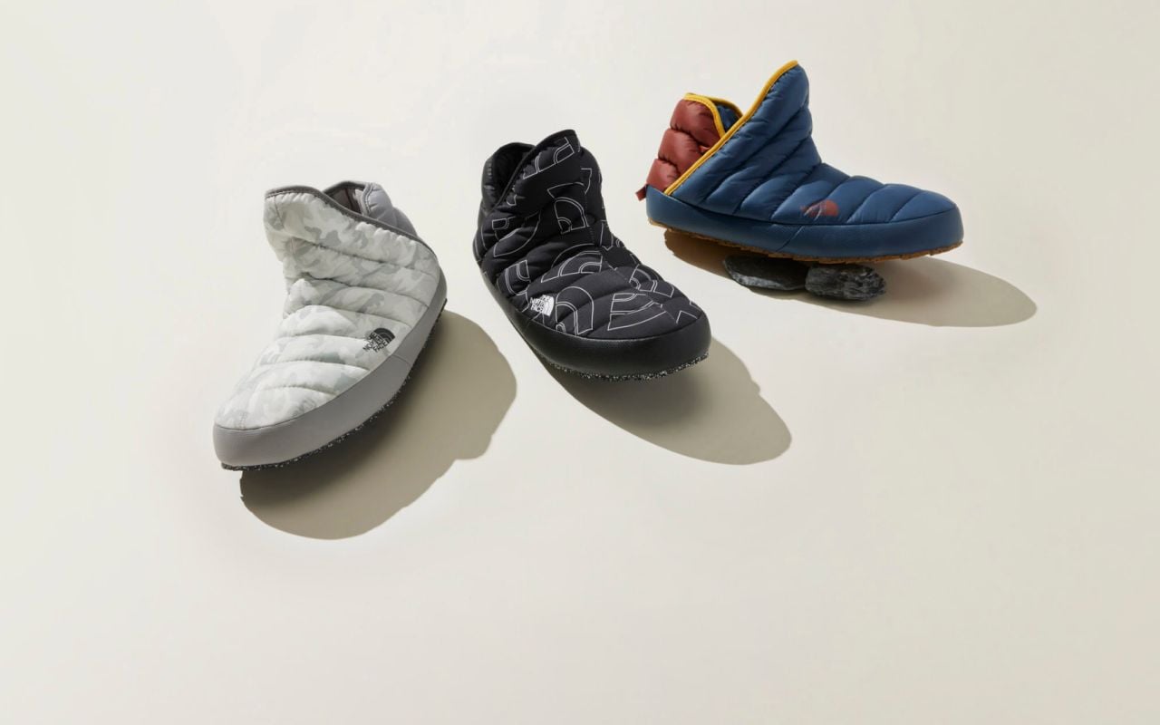 Text reads: “The comfort of home, everywhere you roam” next to two pairs of ThermoBall™ Traction Booties.