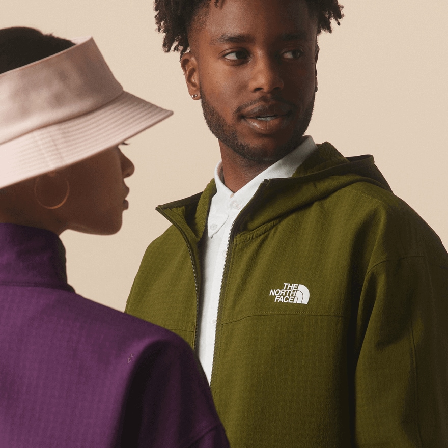 Two people standing near each other in The North Face new arrivals. 