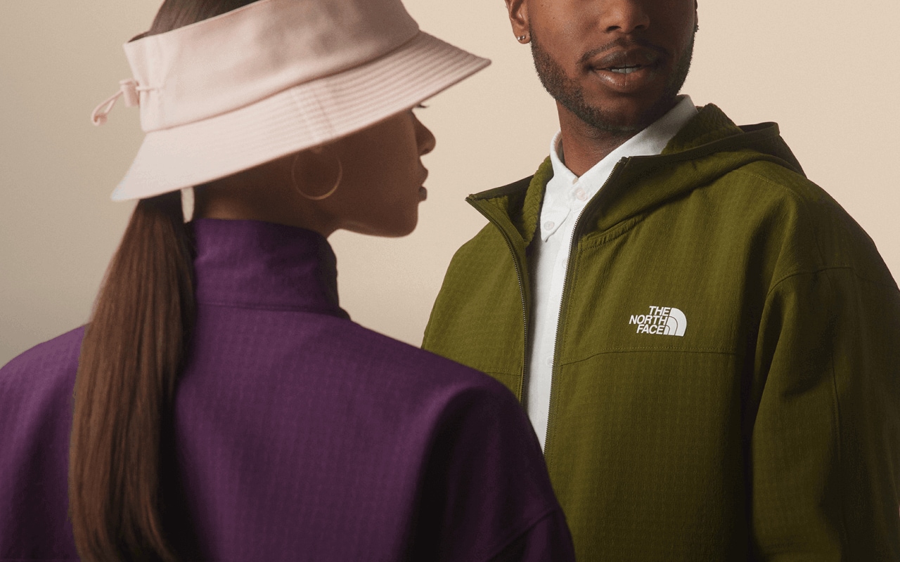  Two people standing near each other in The North Face new arrivals. 
