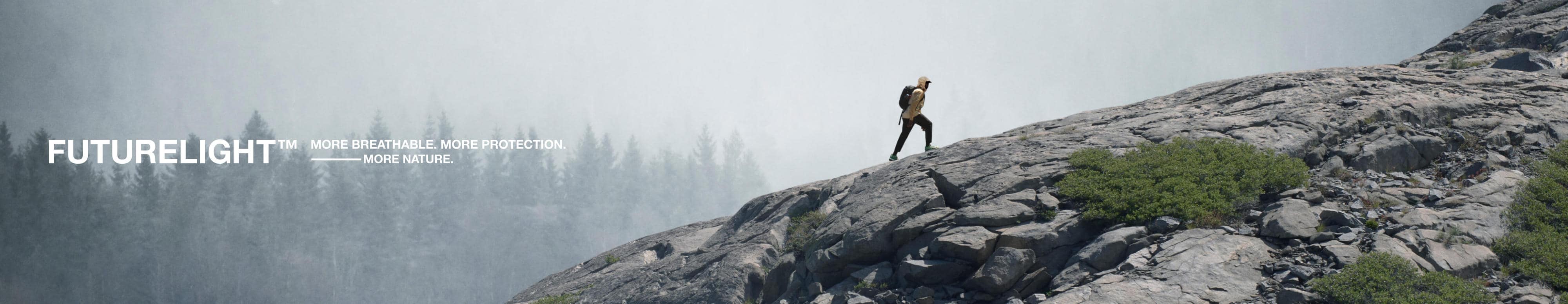 A hiker makes their way towards the summit while wearing the Frontier FUTURELIGHT™ Jacket.  