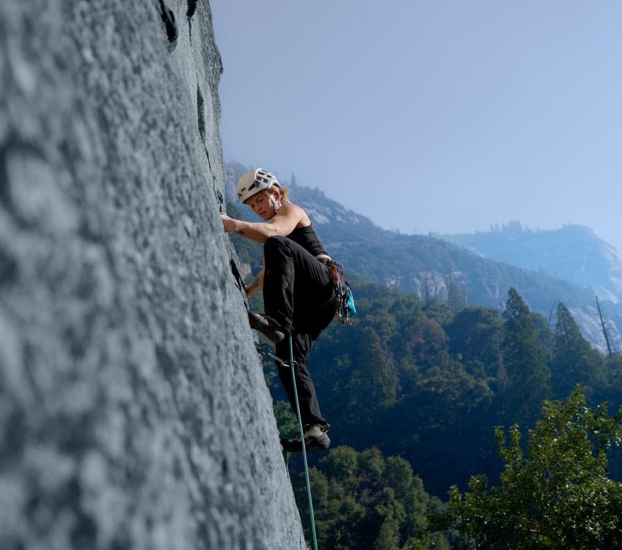 Athlete Emily Harrington is climbing the face of a mountain in gear from The North Face. 