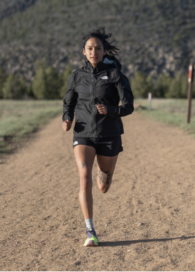 Image of Athlete Development Program member Laura Cortez standing on a trail in Mexico, wearing gear from The North Face.