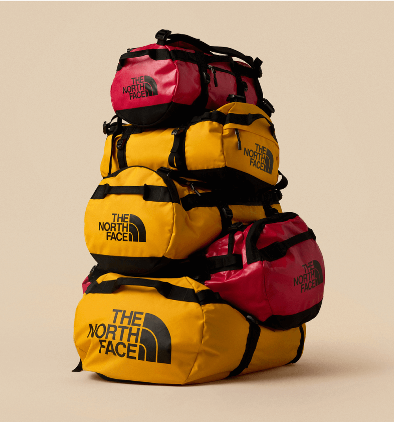 Studio shot of various colors of Base Camp Duffels stacked in a pyramid.