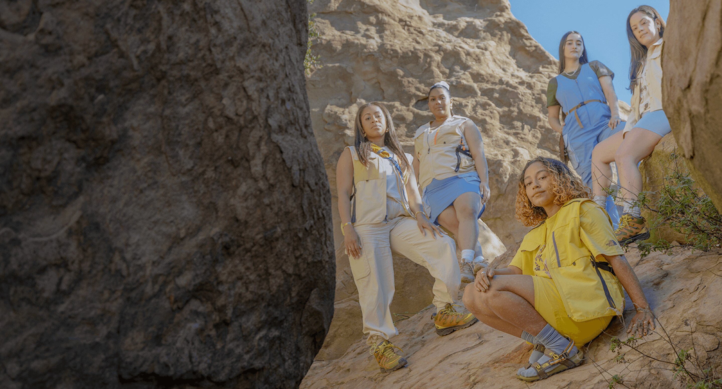 Explore Fund council member Evelynn Escobar and four women pose on granite boulders wearing gear from The North Face Hike Clerb Capsule Collection. 