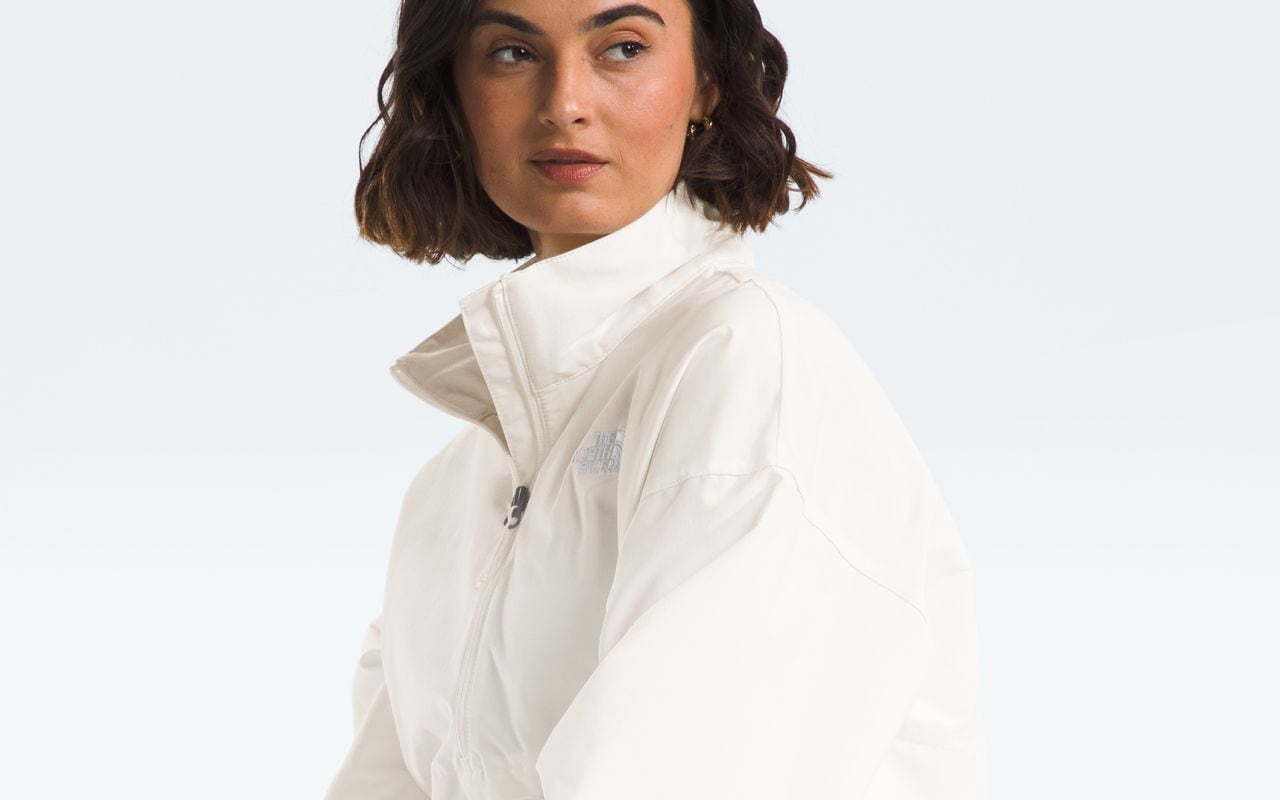 Studio shot of a model wearing a tonal outfit featuring the Easy Wind Collection from The North Face.