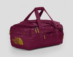 Magenta duffle bag with gold accents. 
