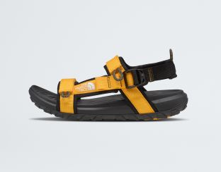 Studio shot of a yellow sandal from The North Face.