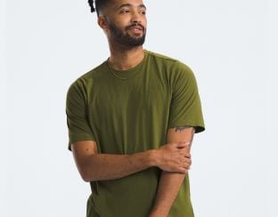 Studio shot of a man in a green tee from The North Face.