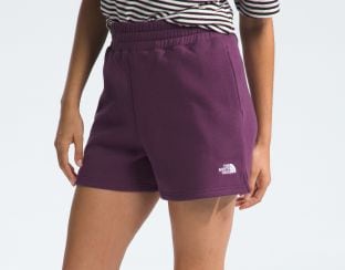 Studio shot of a woman in purple shorts from The North Face.